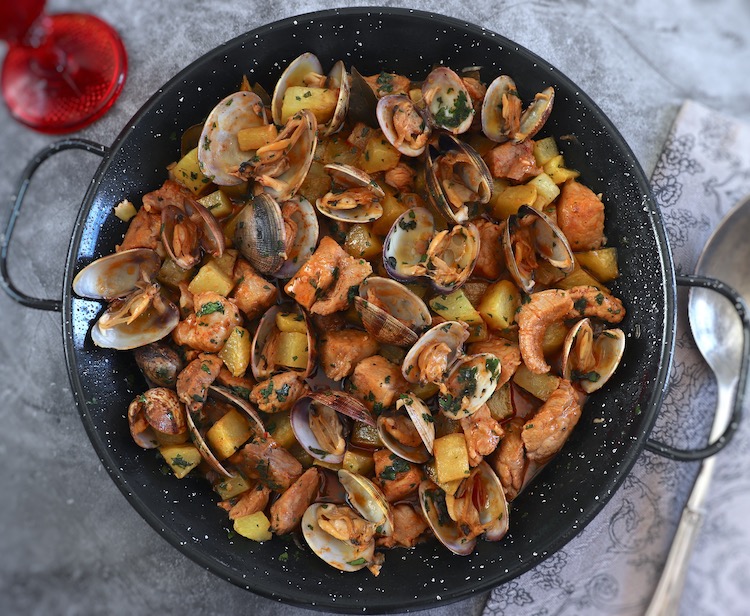 Portuguese pork with clams on a large skillet