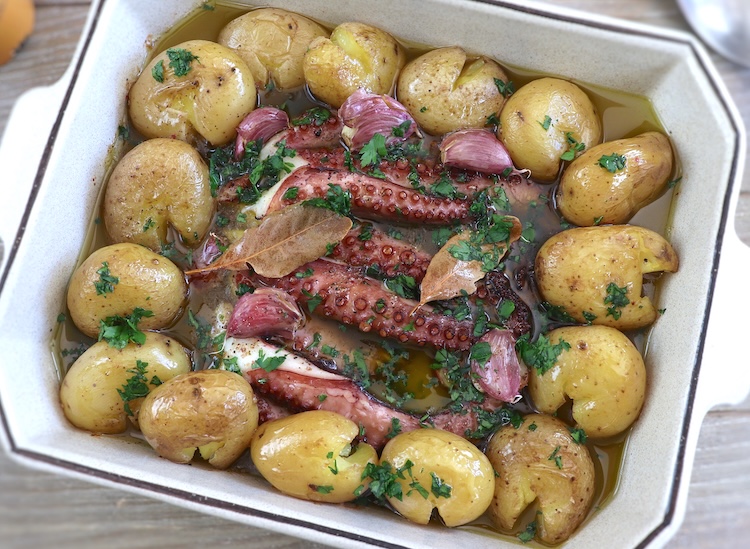 Portuguese baked octopus with potatoes in a baking dish