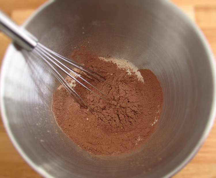 Sugar, flour, baking powder, chocolate powder in a large bowl