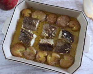 Baked cod with "punched" potatoes on a baking dish