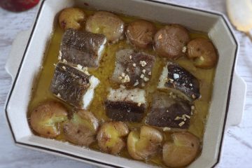 Baked cod with "punched" potatoes on a baking dish