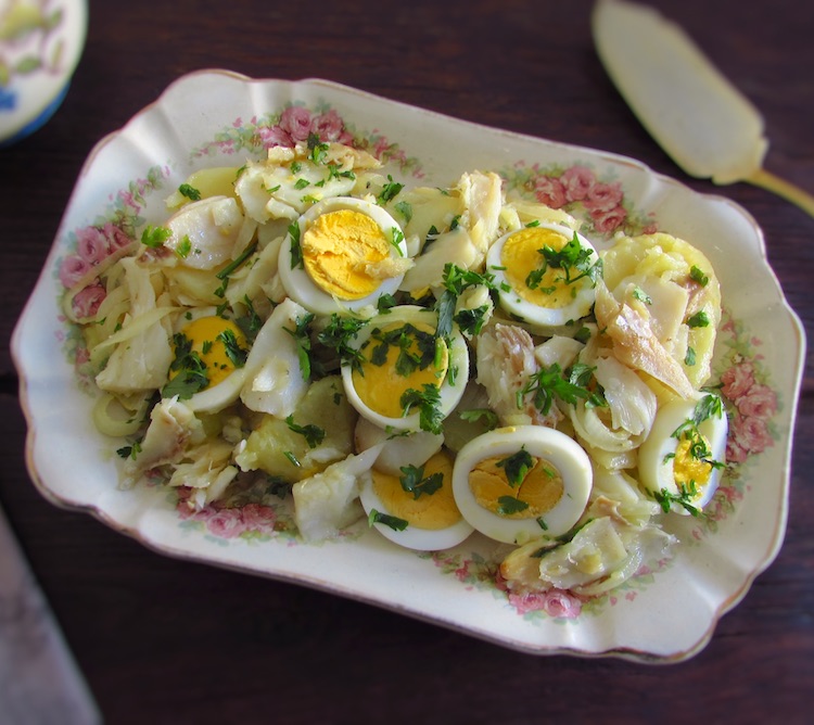 Salt cod with potatoes and eggs on a platter