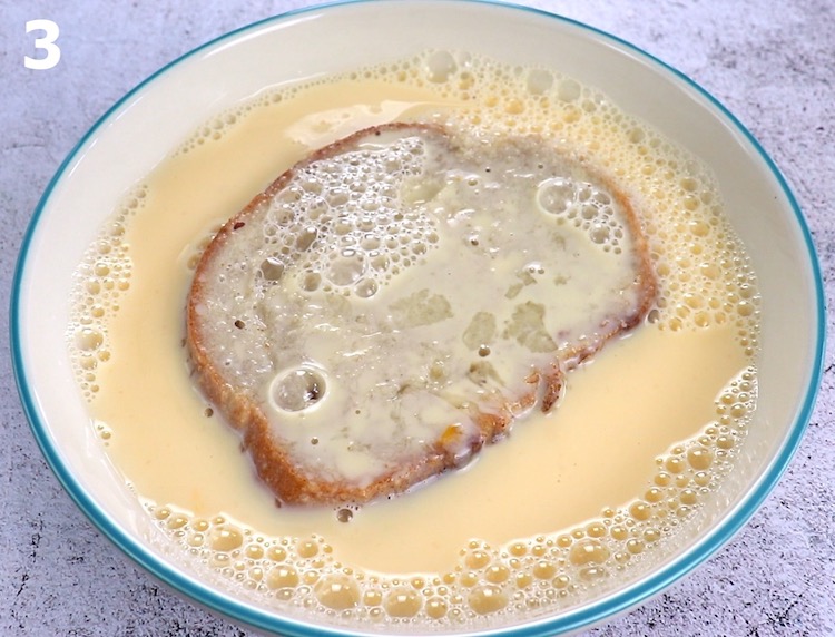 Slice of bread dipped in a mixture of egg and milk in a shallow dish