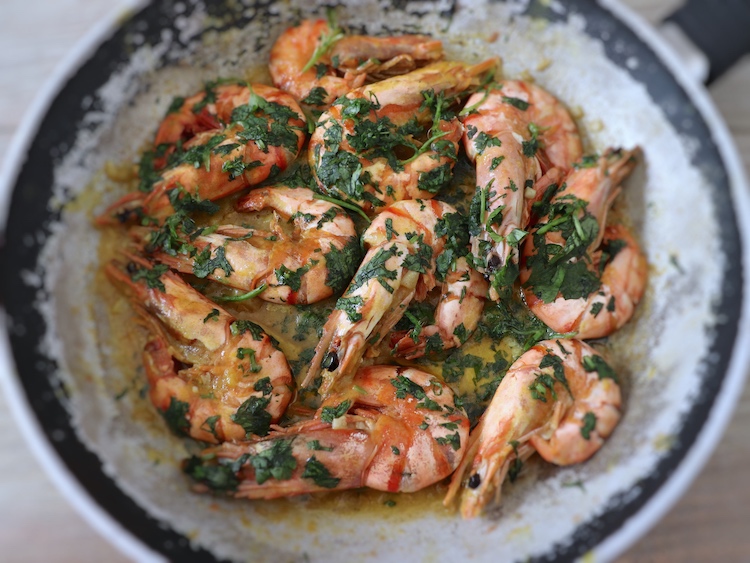 Fried shrimps with mustard on a frying pan