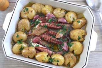Baked octopus with potatoes on a baking dish