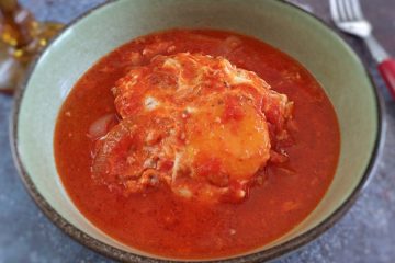 Poached eggs in tomato sauce on a dish bowl