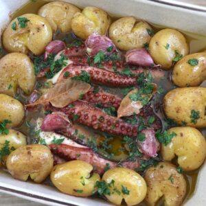 Portuguese baked octopus with potatoes in a baking dish