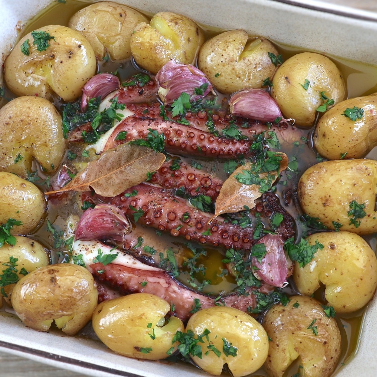 Portuguese baked octopus with potatoes in a baking dish