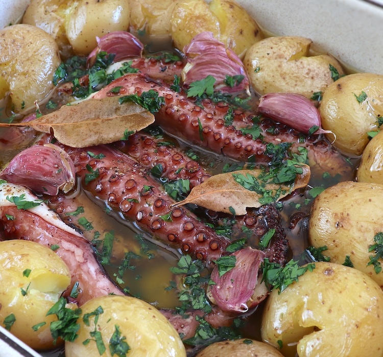 Portuguese baked octopus with potatoes in a baking dish