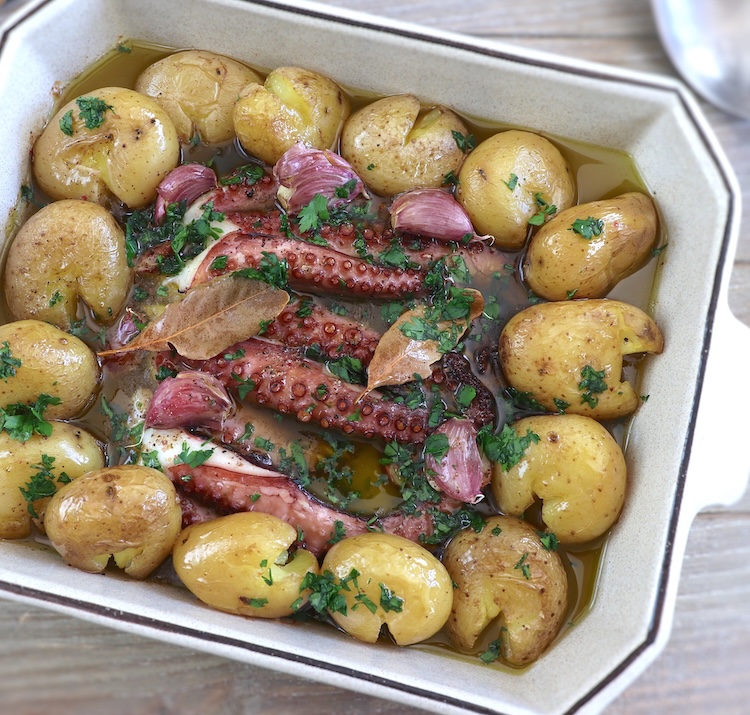 Portuguese baked octopus with potatoes in a baking dish