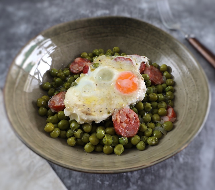 Portuguese peas with poached eggs and chouriço in a dish bowl