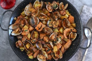 Portuguese pork with clams on a large skillet