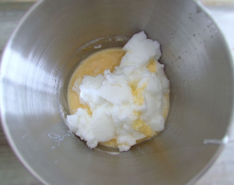 Egg yolks, condensed milk and whipped egg whites on a bowl