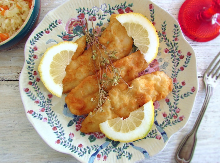 Fish fillets with lemon slices on a plate