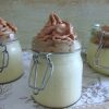 Orange mousse with chocolate cream on glass bowls