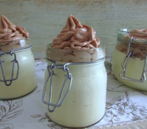 Orange mousse with chocolate cream on glass bowls