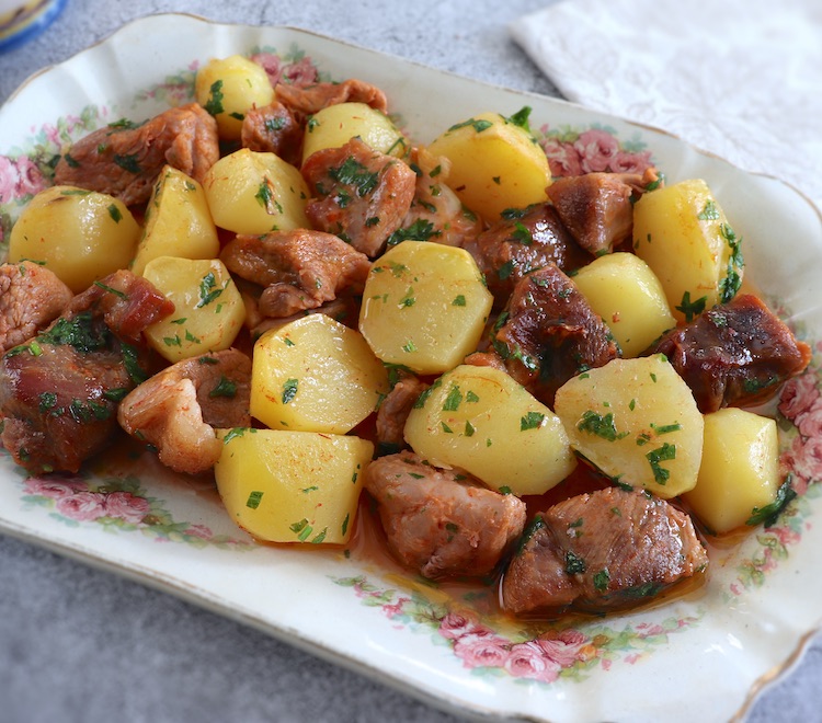 Baked pork with potatoes on a platter