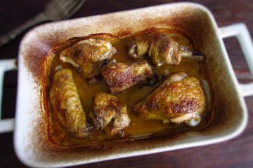 Chicken in the oven with rice on a baking dish