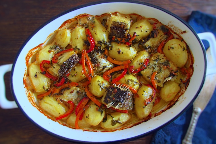 Cod in the oven drizzled with olive oil on a baking dish