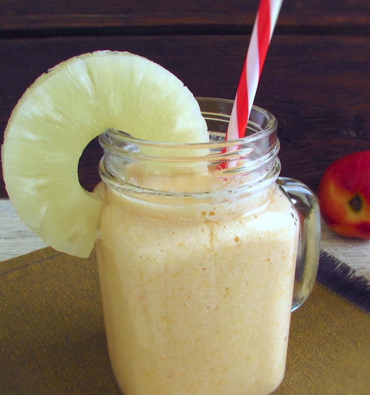 Peach and pineapple milkshake on a glass mug