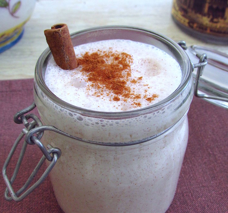 Pear and cinnamon milkshake on a glass cup