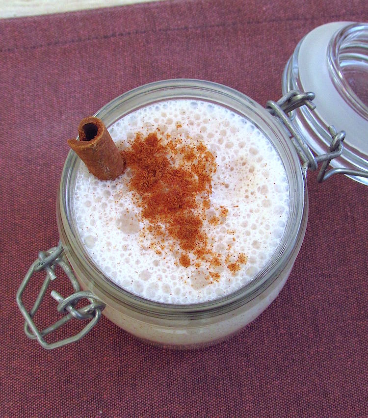 Pear and cinnamon milkshake on a glass cup