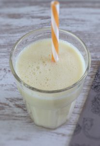 Pineapple milkshake on a glass cup