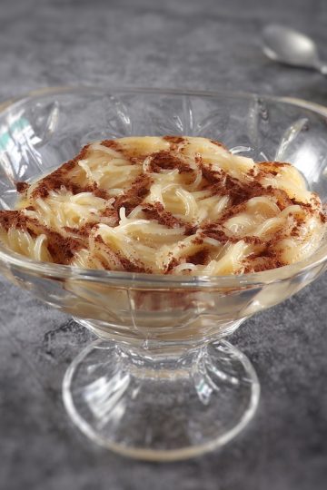 Portuguese vermicelli pudding on a glass bowl