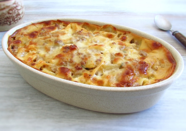 Tagliatelle with minced meat and pineapple in the oven on a baking dish