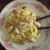 Chicken with spaghetti, pineapple and mushrooms on a plate