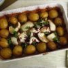 Cuttlefish with potatoes in the oven on a baking dish