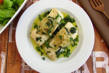 Hake loins with coriander on a plate