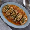 Hake with tomato and coriander on a platter