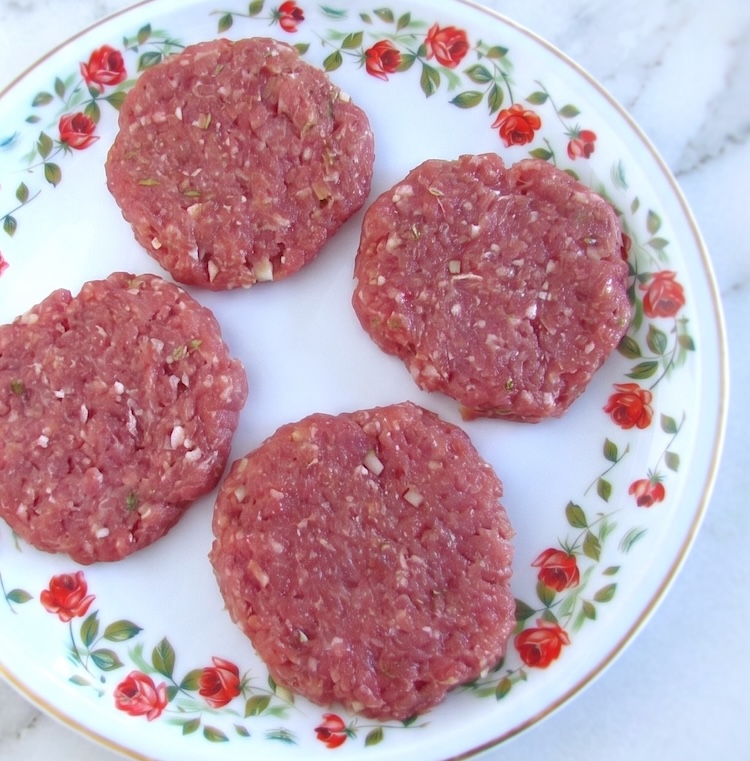 Carne picada em forma de hambúrgueres num prato