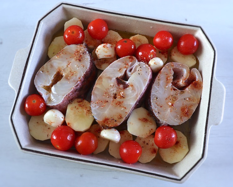 Ling fish, potatoes and cherry tomato on a baking dish