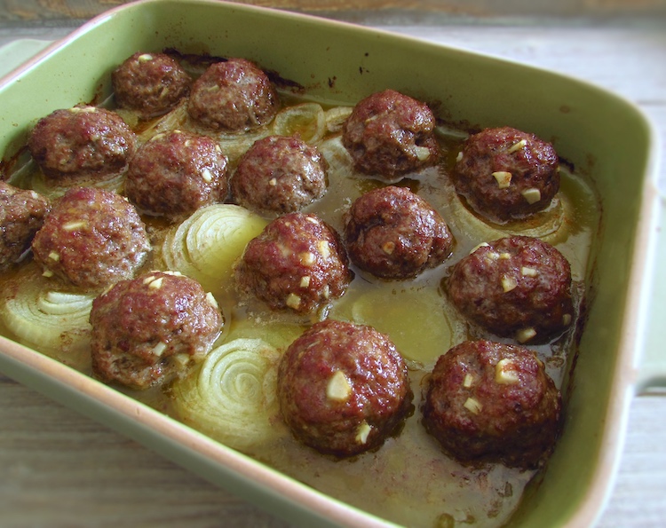 Meatballs in the oven on a baking dish