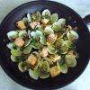 Salmon with clams on a frying pan