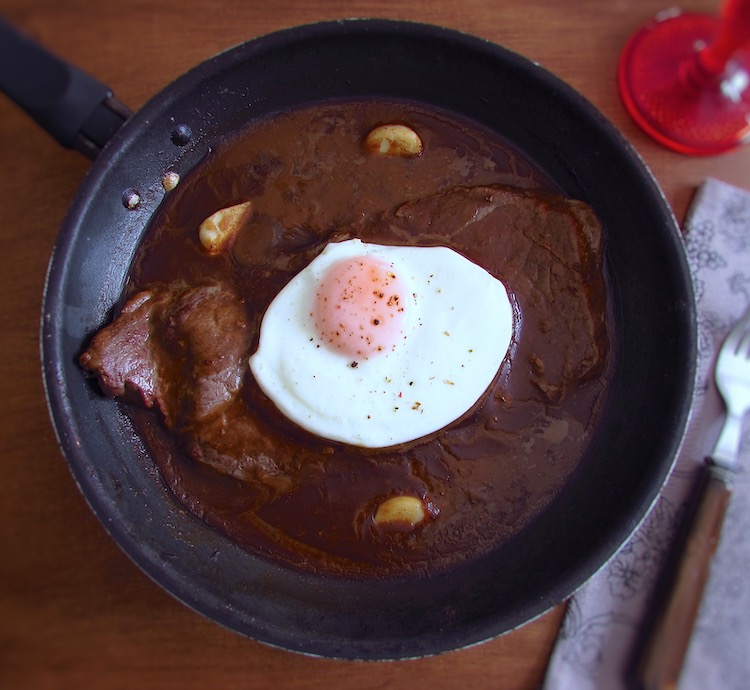 Steak with coffee sauce on a frying pan