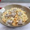 Veal cubes with pasta and cream on a dish bowl