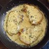 Pork chops with béchamel sauce on a frying pan