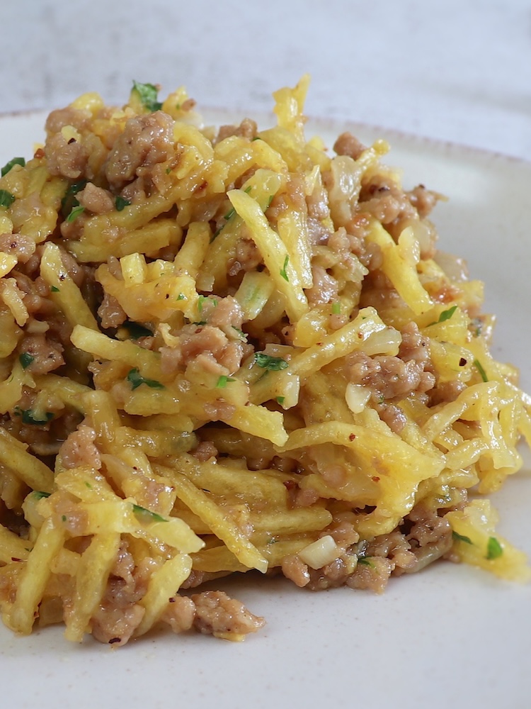 Ground meat, potatoes and eggs on a plate