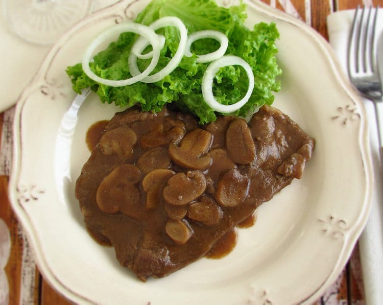 Steak with coffee and mushrooms on a plate