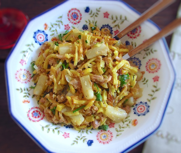 Tuna, potatoes, eggs and pineapple on a dish bowl