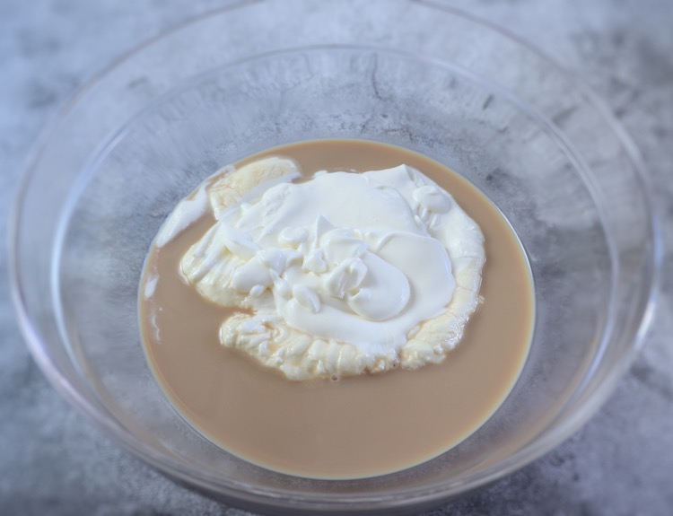Whipped cream, condensed milk and coffee on a glass bowl