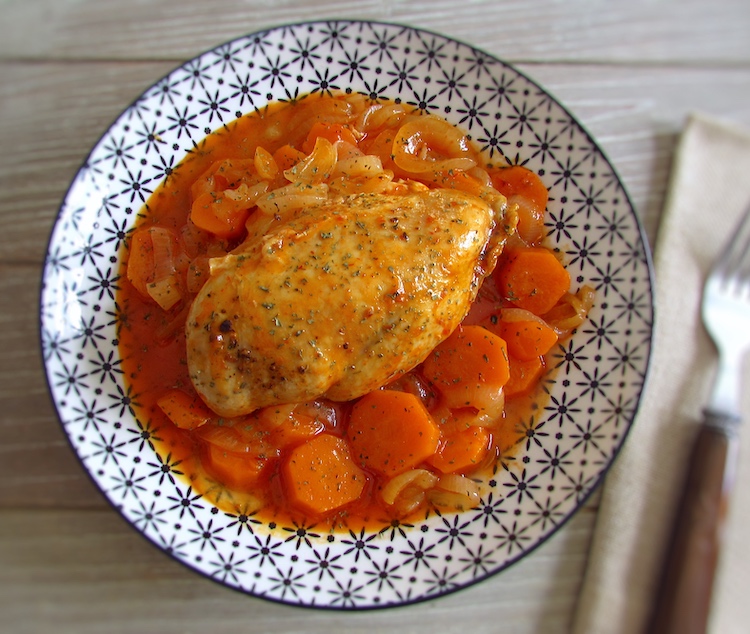 Stewed chicken breast with carrot on a plate