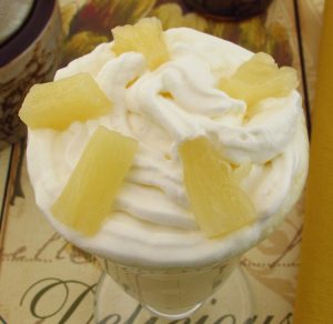 Pineapple and mango milkshake on a glass bowl