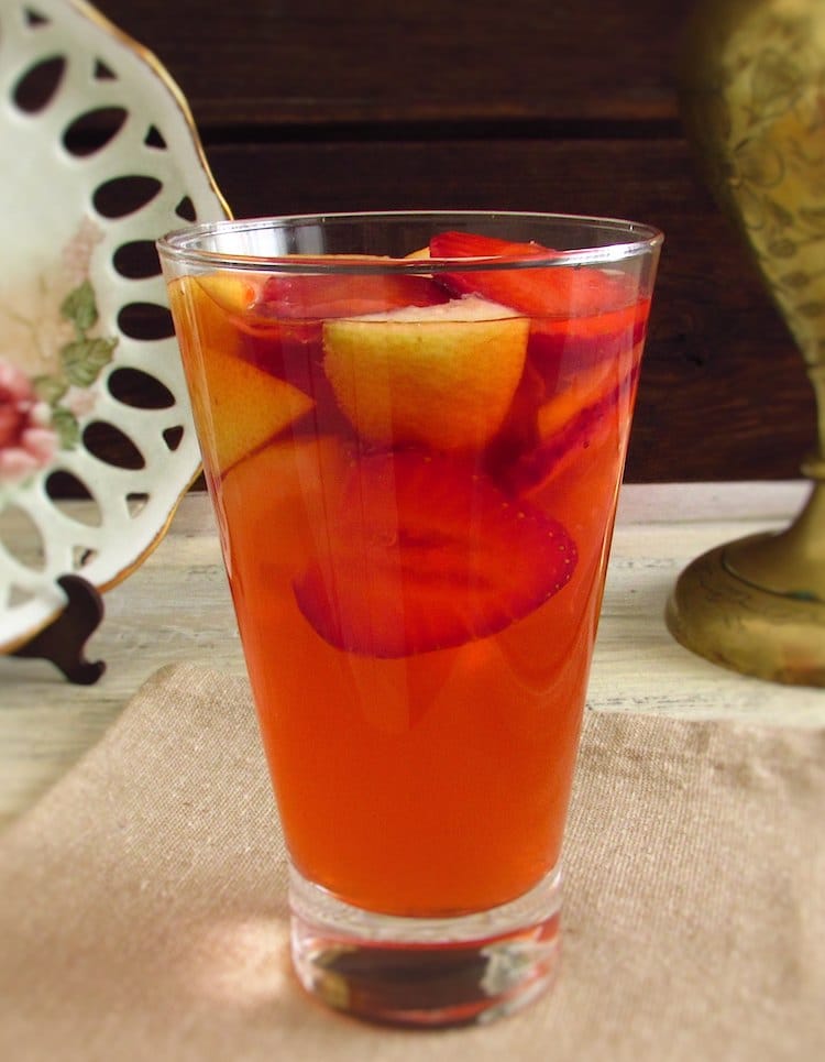 Lemonade with strawberries on a glass cup