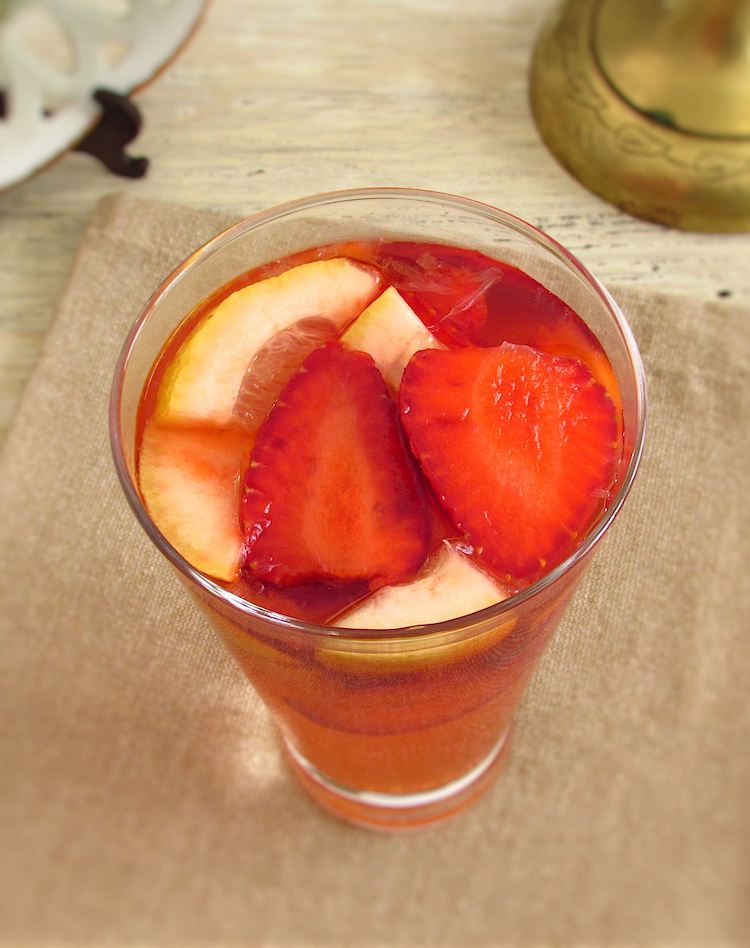 Lemonade with strawberries on a glass cup