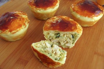 Mini chicken pies on a wooden board