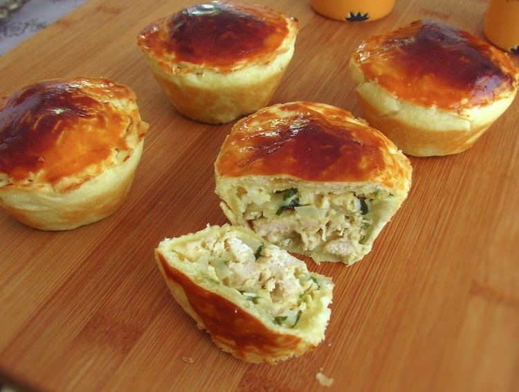 Mini chicken pies on a wooden board